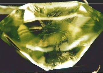 In this Peridot you can see the heat has caused the inclusion to expand, reducing the value