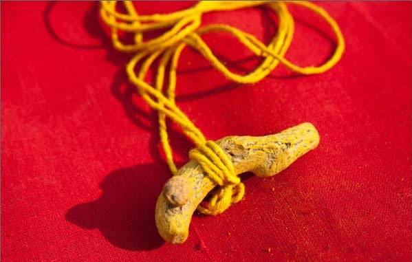 Turmuric piece with yellow sacred thread