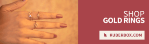 Hand wearing gold and diamond rings from KuberBox