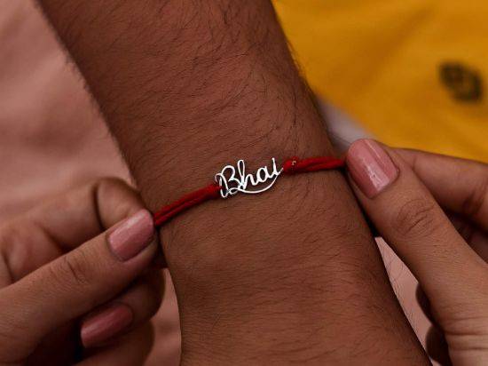 Bhai Silver Rakhi Pendant on wrist