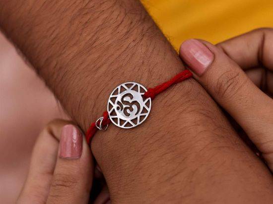 The Om Silver Rakhi Pendant on wrist