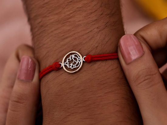 Cutwork Ganesha Silver Rakhi on wrist