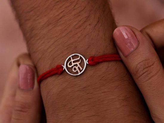 Inscribed Shree Silver Rakhi on wrist