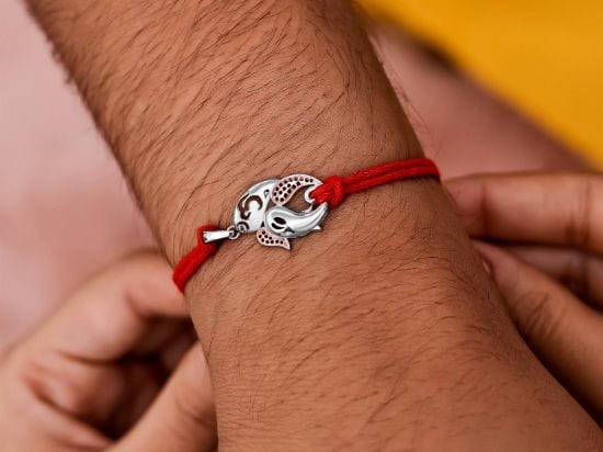 Gaja-Om Silver Rakhi Pendant on wrist